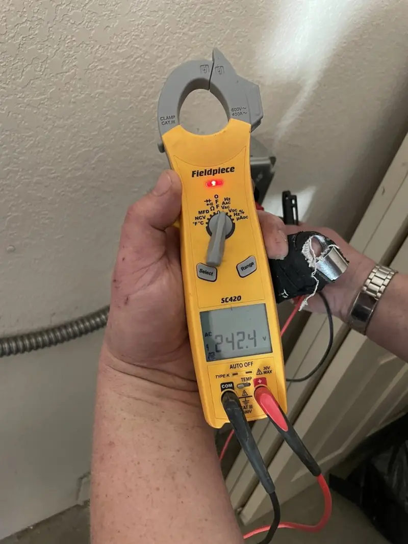 Voltage testing with clamp meter during Ceiling Fan Installation in Shelter Island